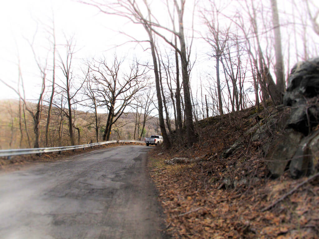 A dirt road beside a lake